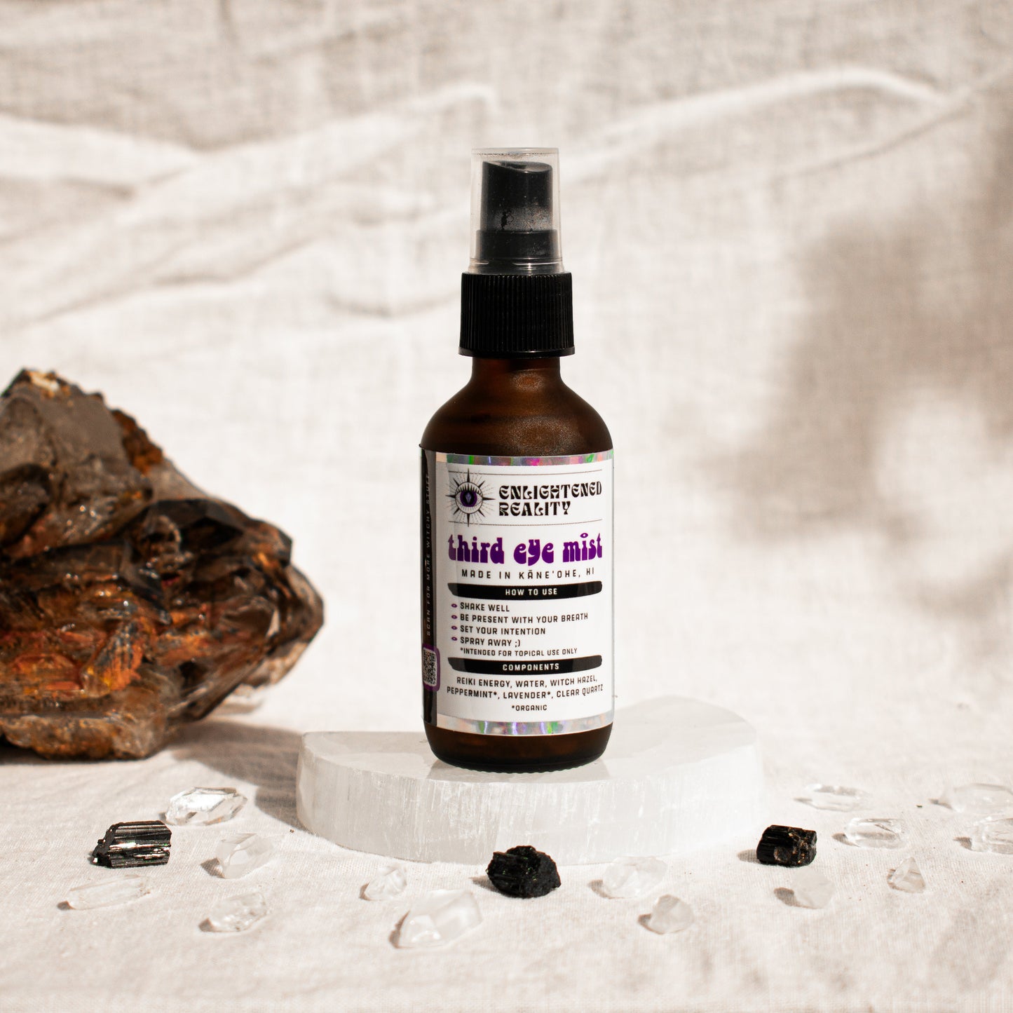 Close-up of organic chakra mist bottle label with Reiki-charged ingredients for energy healing