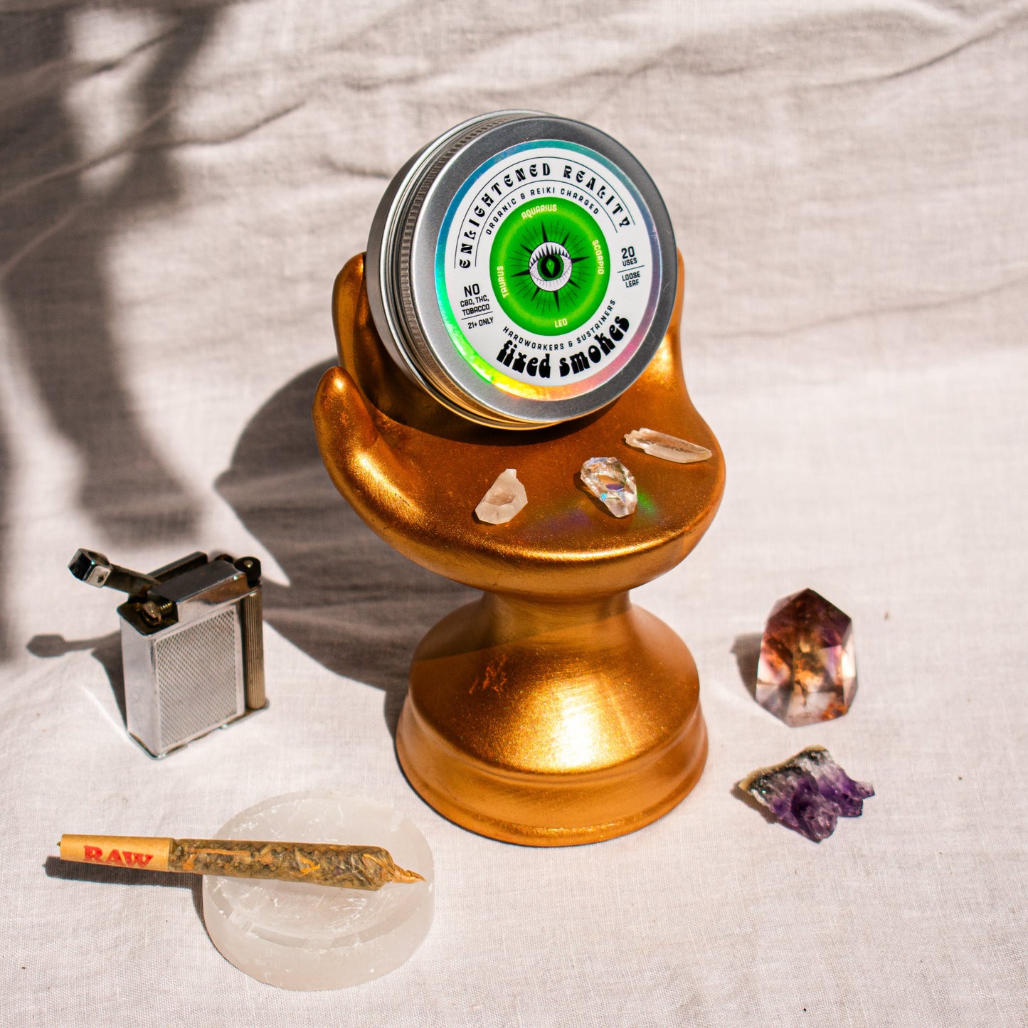 Organic Herbal Smoking Blend in metal tin on display stand surrounded by crystals for energetic balance and mindfulness