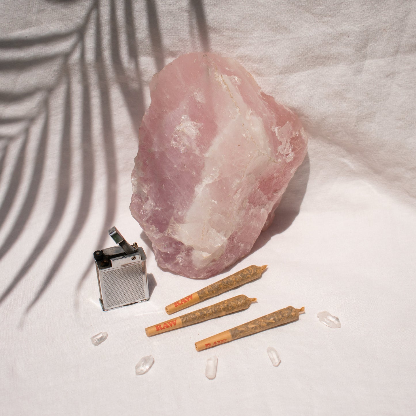 Trio of Organic single Pre Rolls Herbal Smoking Blends displayed with rose quartz for astrological and spiritual rituals