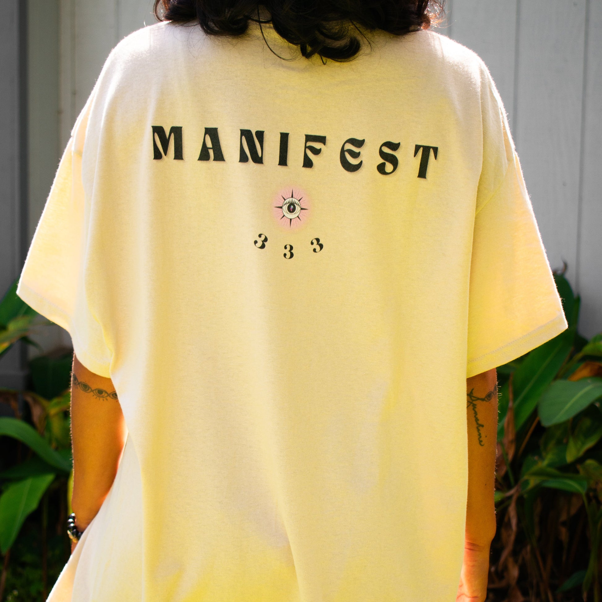 Close-up of Align Your Shakas chakra-inspired graphic printed on 100% cotton t-shirt