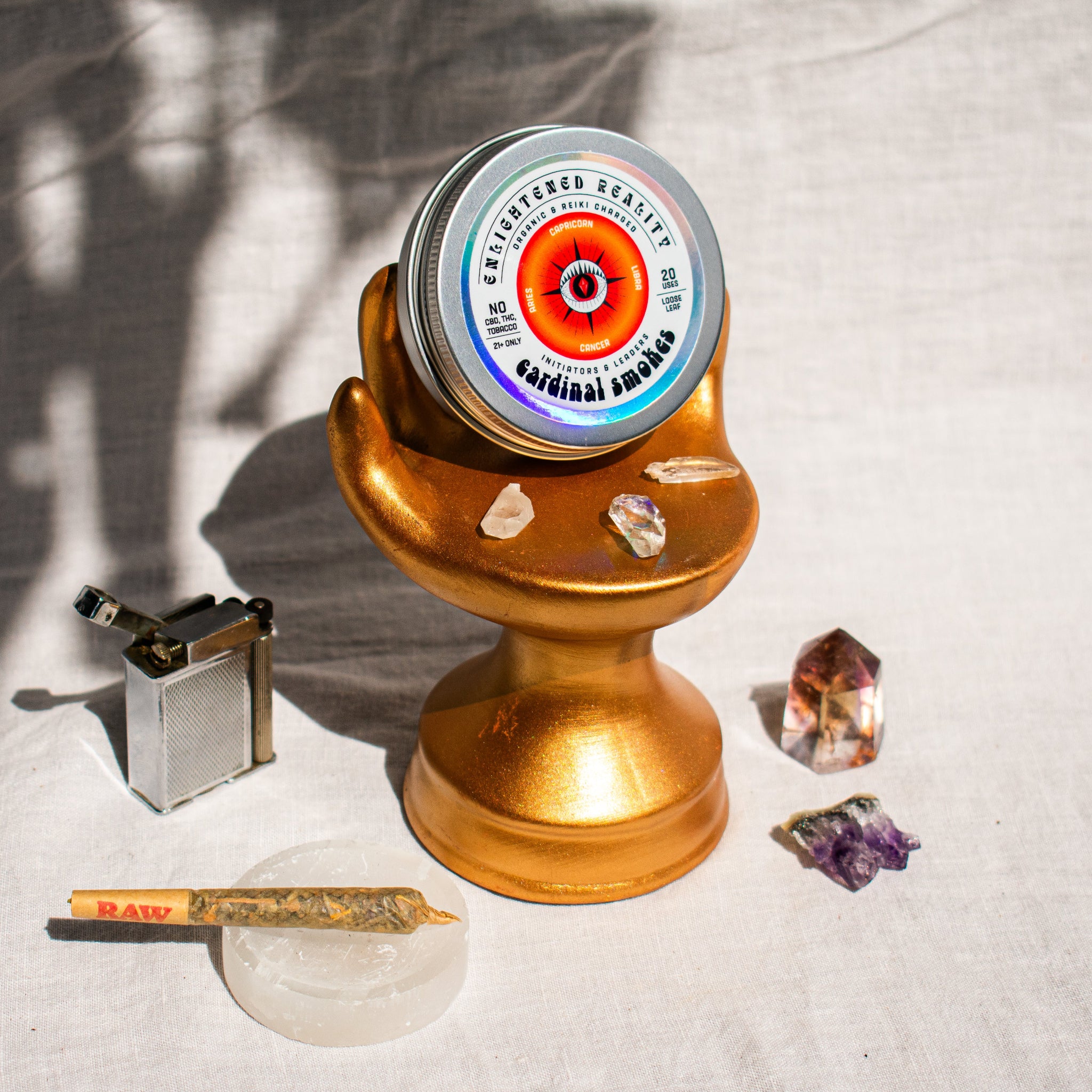Organic Herbal Smoking Blend in metal tin on display stand surrounded by crystals for energetic balance and mindfulness