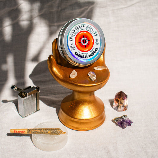 Organic Herbal Smoking Blend in metal tin on display stand surrounded by crystals for energetic balance and mindfulness