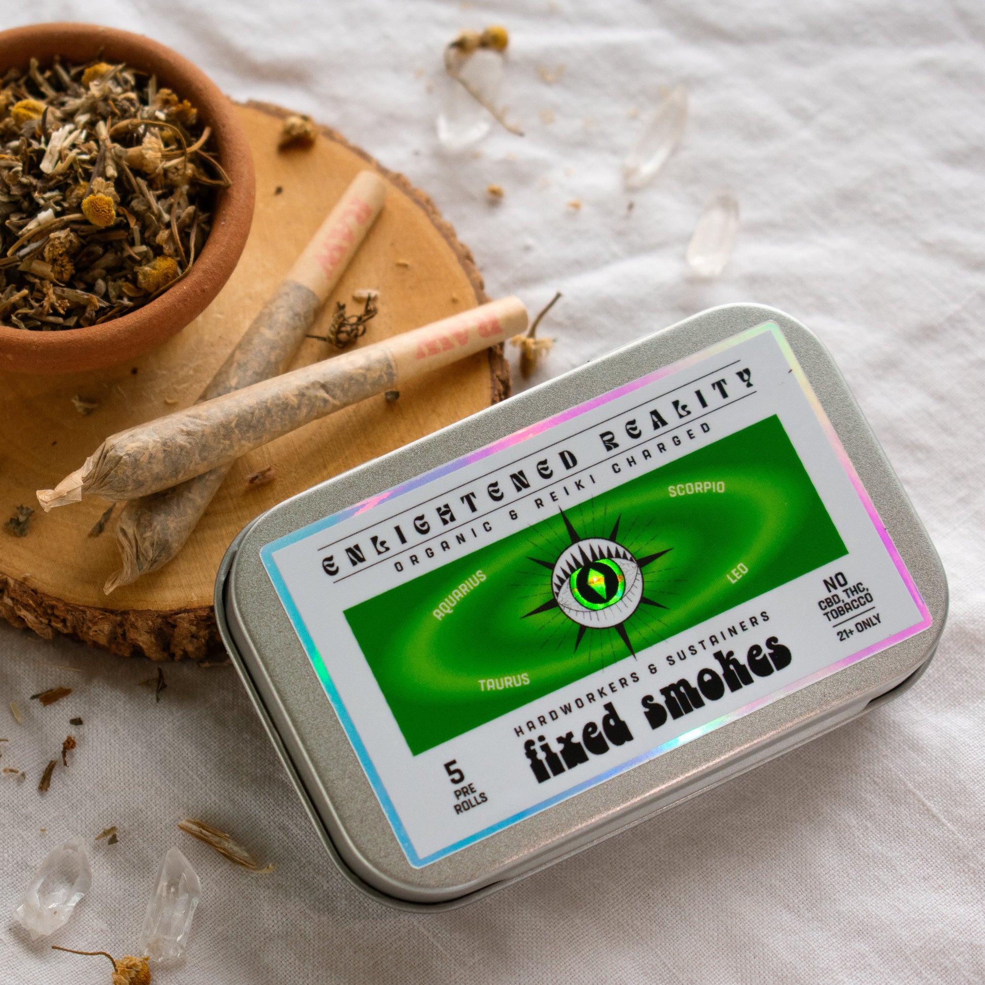 Organic Herbal Smoking Blend in metal tin on display surrounded by crystals for energetic balance and mindfulness