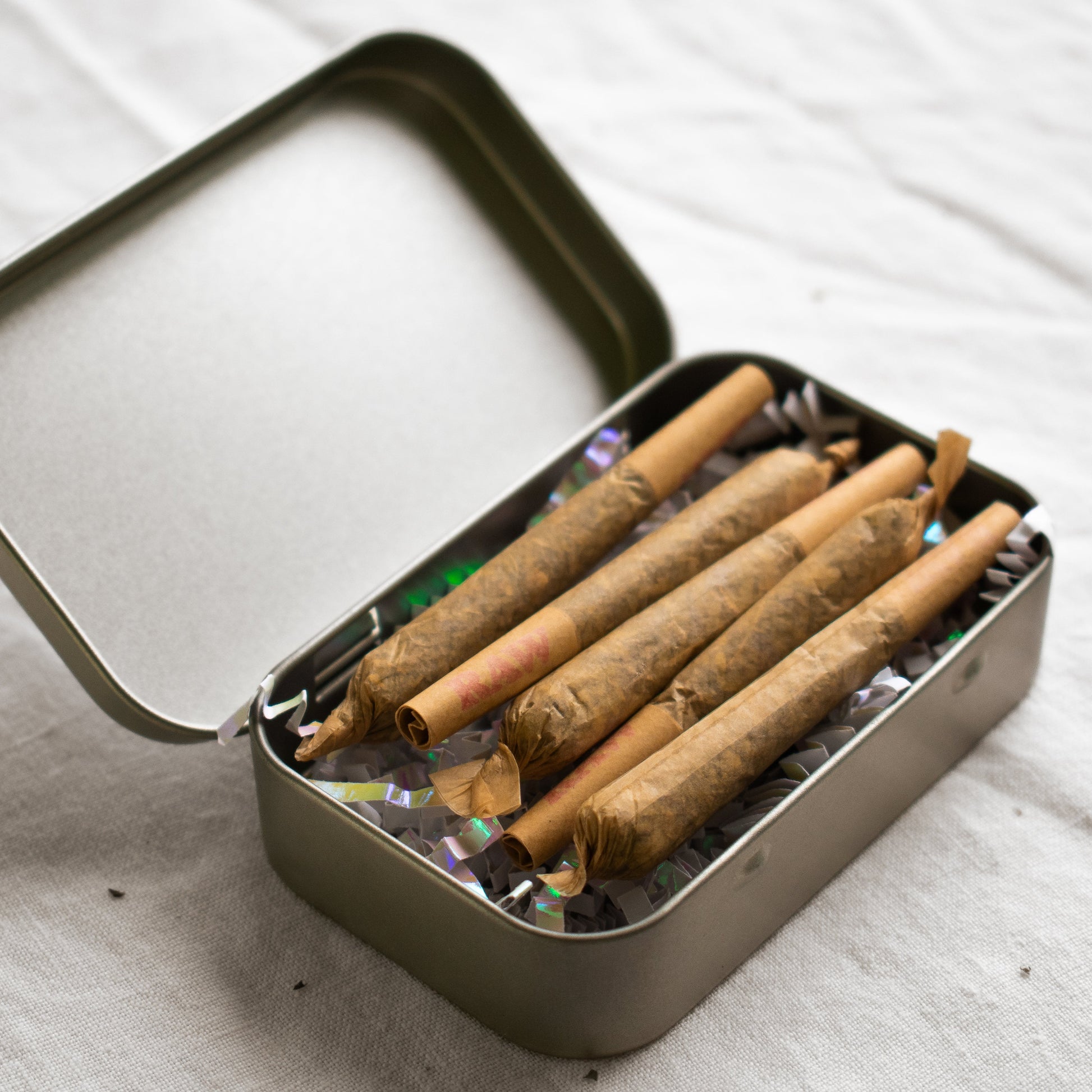Organic Herbal Smoking Blend pre-roll 5 pack in metal tin for energetic balance and mindfulness