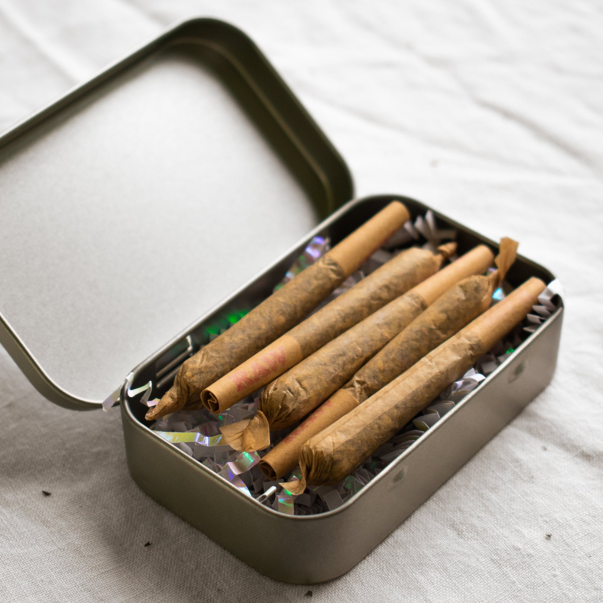 Organic Herbal Smoking Blend pre-roll 5 pack in metal tin for energetic balance and mindfulness