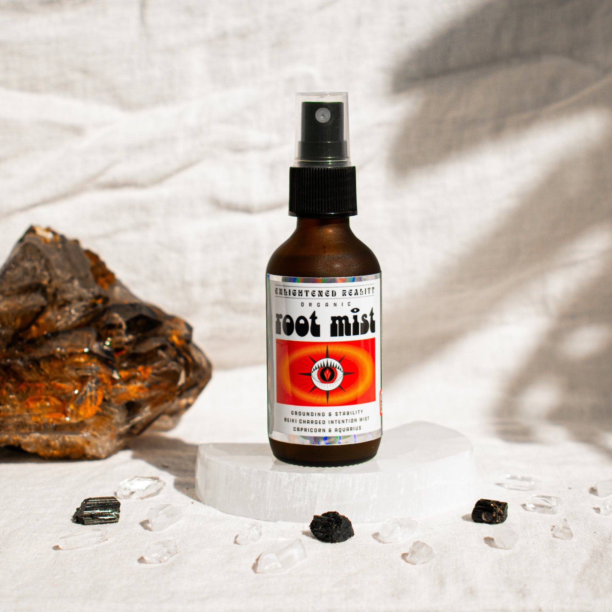 Chakra mist spray for spiritual rituals, shown with meditation crystals 