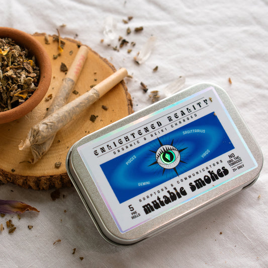 Organic Herbal Smoking Blend in metal tin on display surrounded by crystals for energetic balance and mindfulness