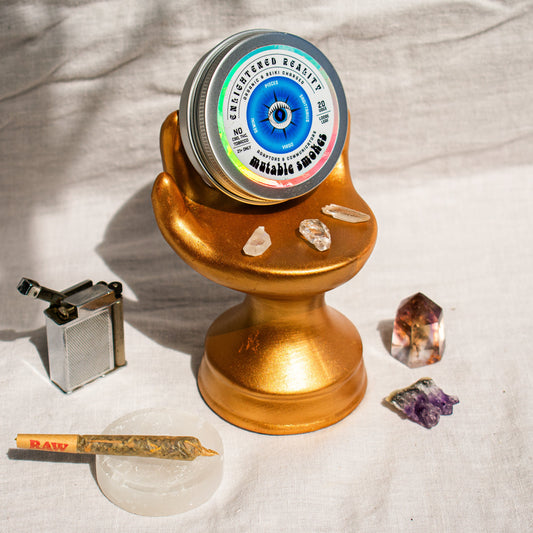 Organic Herbal Smoking Blend in metal tin on display stand surrounded by crystals for energetic balance and mindfulness