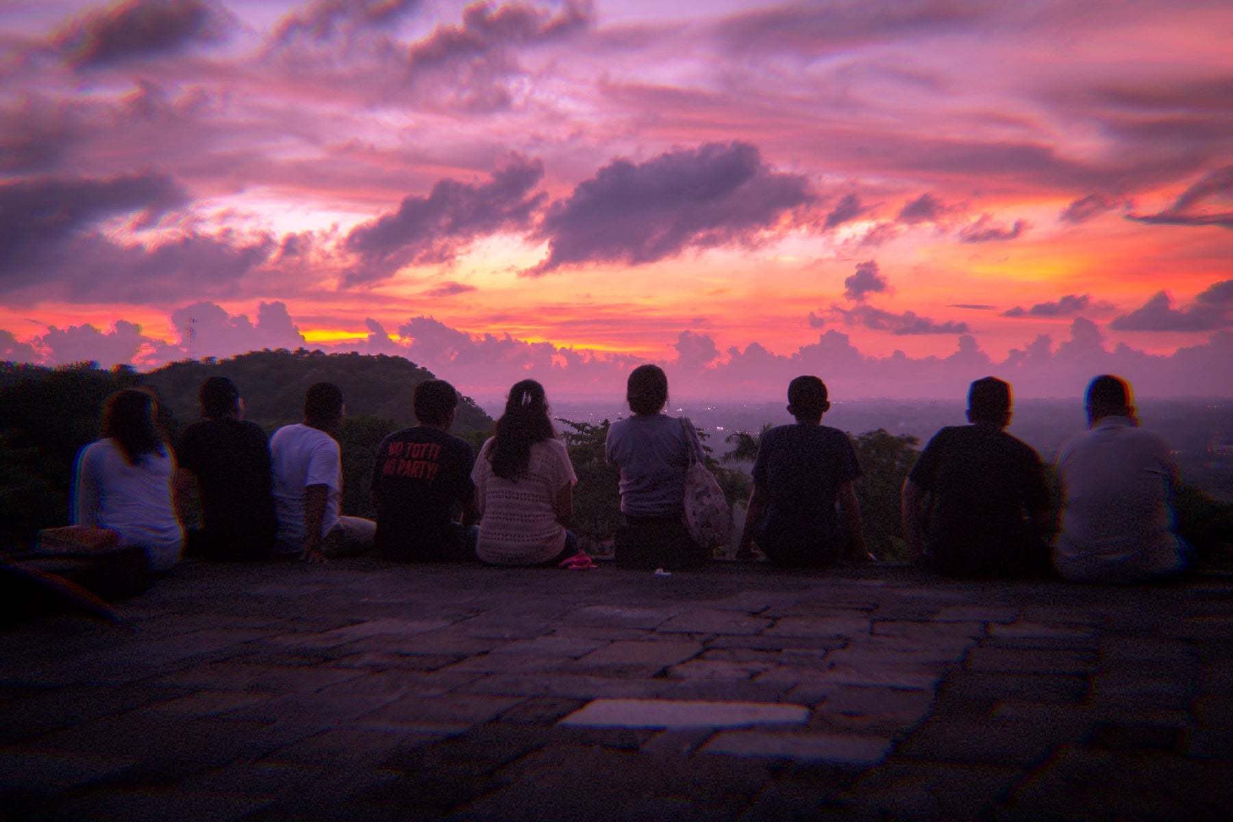 A mindful gathering of diverse people connect through enjoying a sunset together