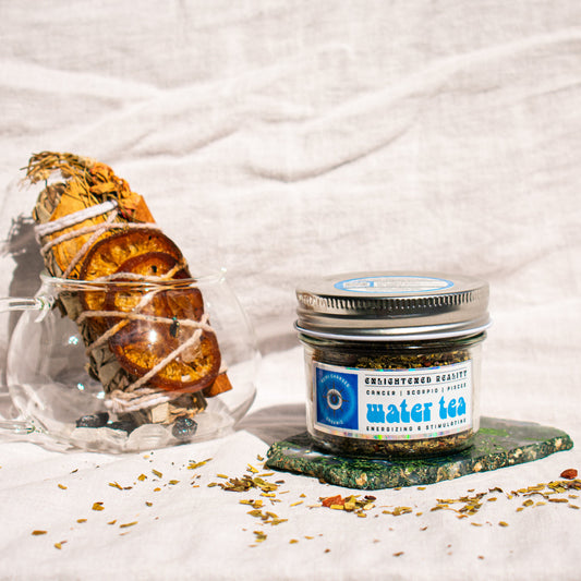 Organic Elemental Herbal Tea in glass jar with crystals for grounding and energy healing