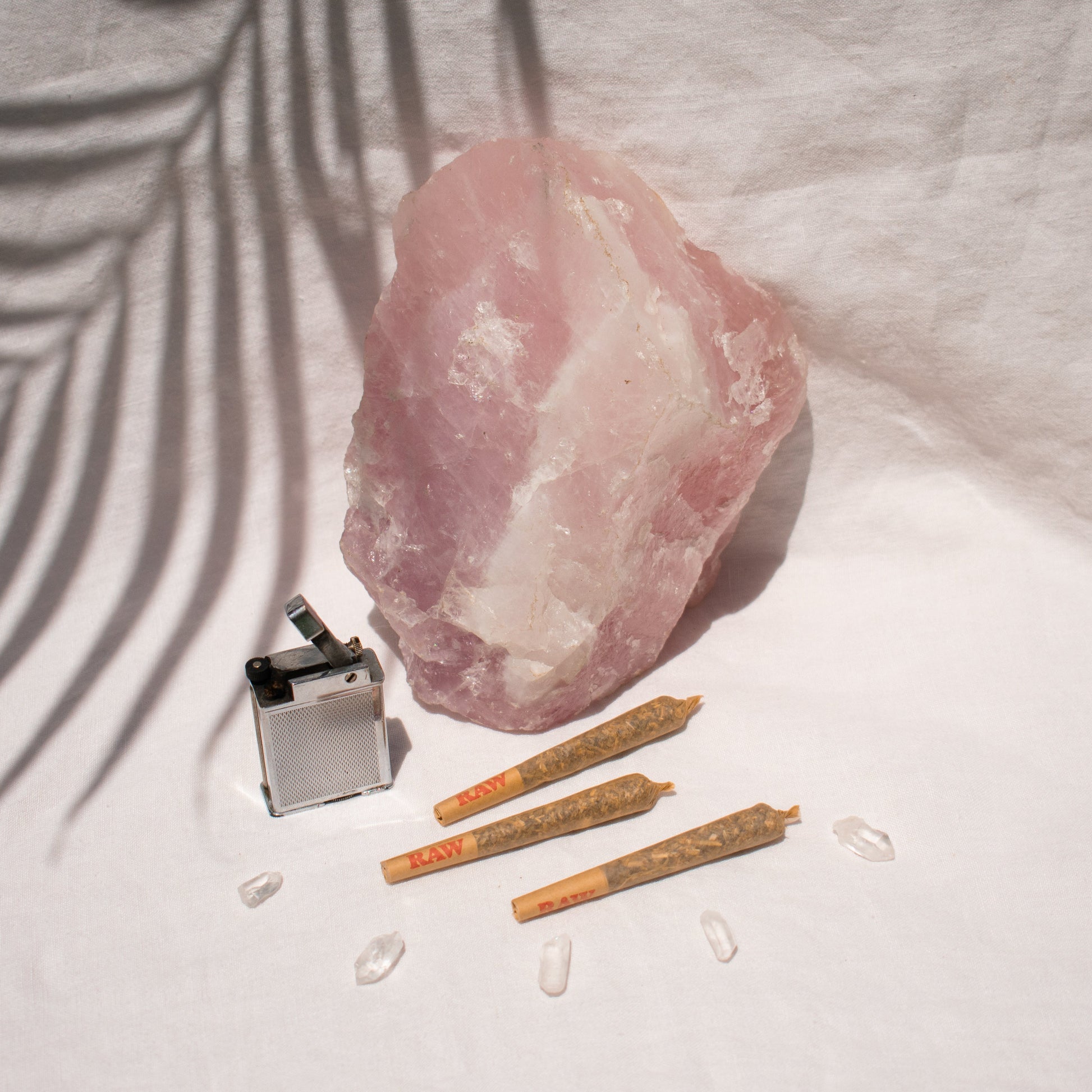 Trio of Organic single Pre Rolls Herbal Smoking Blends displayed with rose quartz for astrological and spiritual rituals