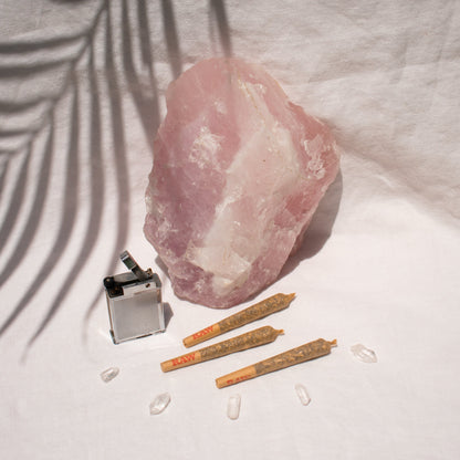 Trio of Organic single Pre Rolls Herbal Smoking Blends displayed with rose quartz for astrological and spiritual rituals