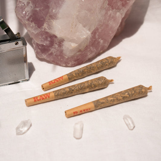 Trio of Organic single Pre Rolls Herbal Smoking Blends displayed with rose quartz for astrological and spiritual rituals